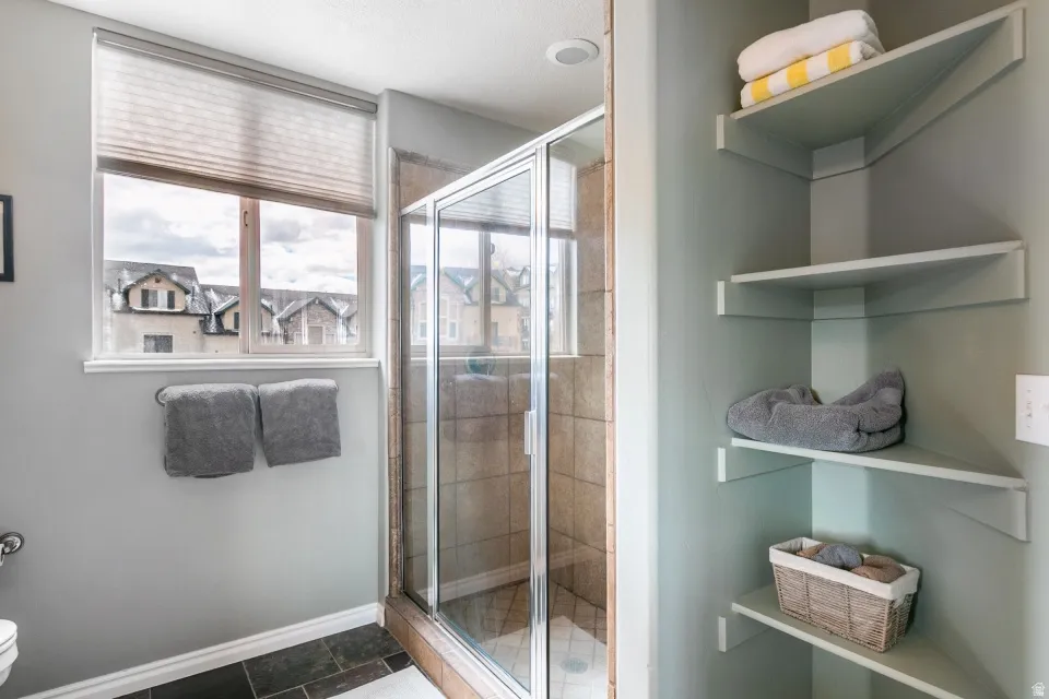 Full bathroom with a shower stall and toilet