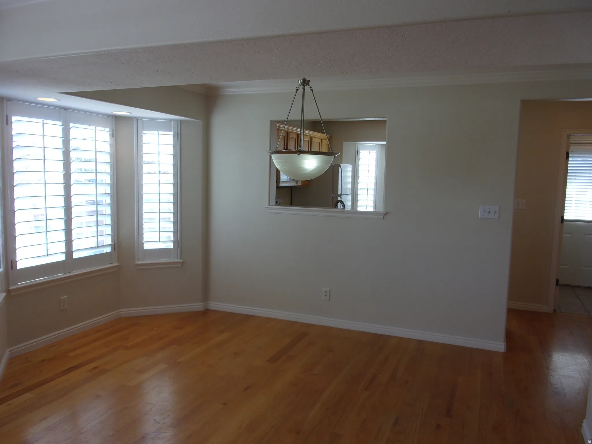 Unfurnished dining area featuring ornamental molding and wood finished floors