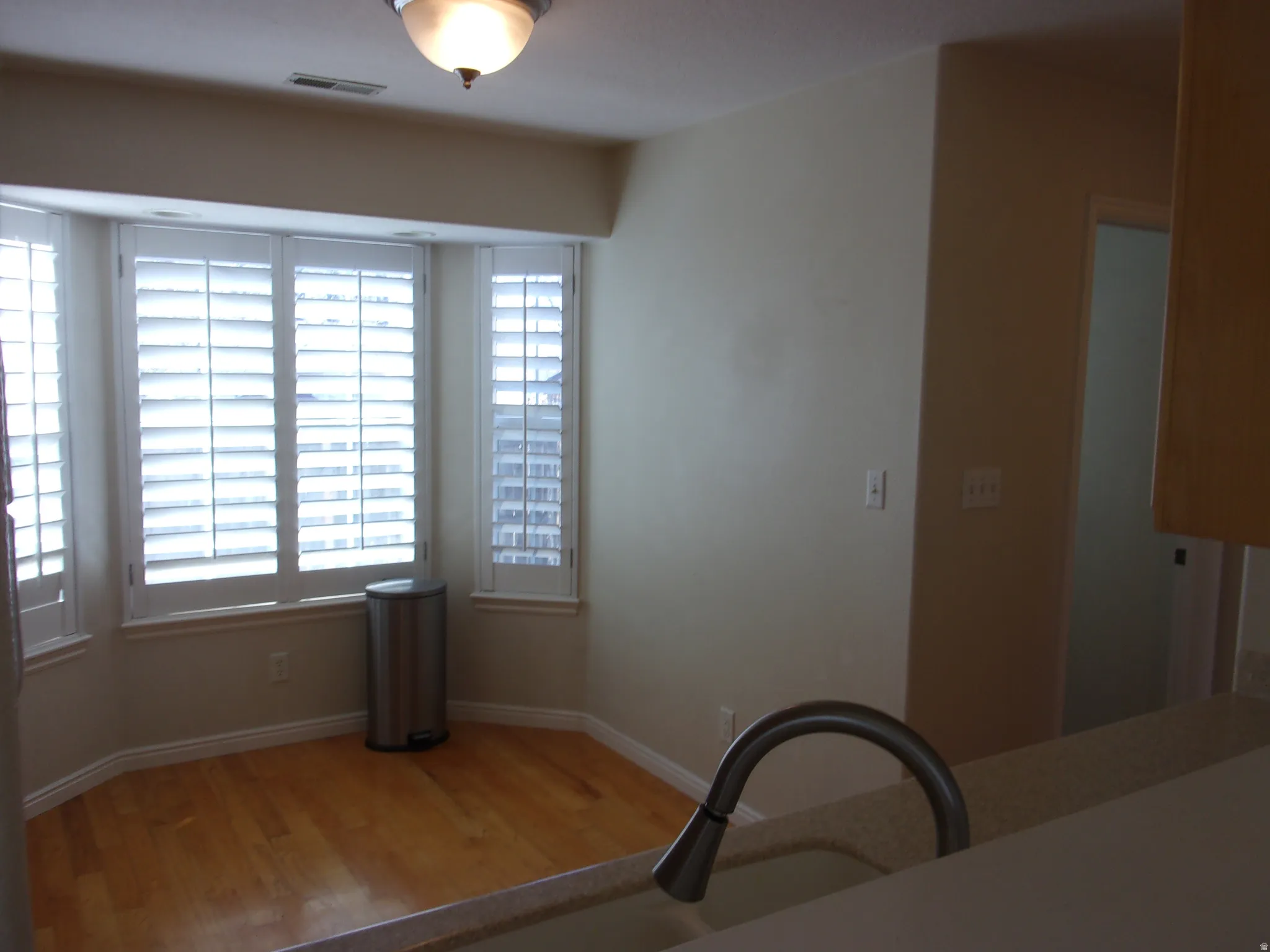 Dining room featuring light wood-type flooring and baseboards