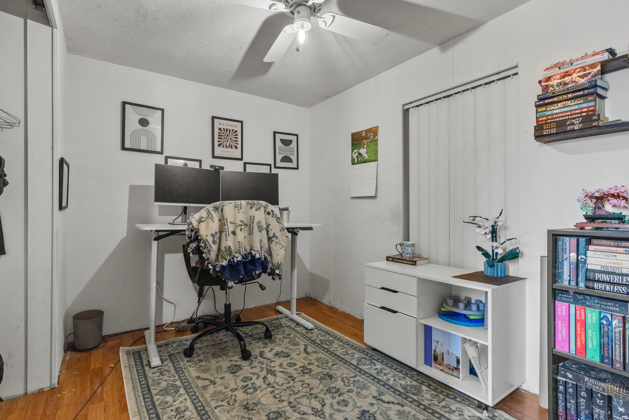 Office space featuring light wood-style floors and a ceiling fan