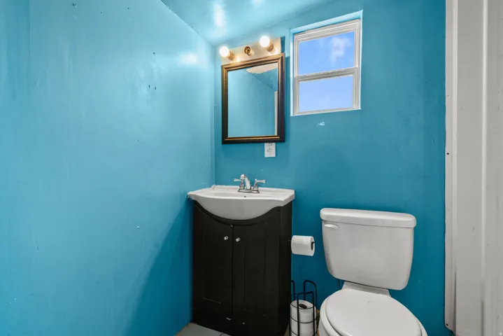 Bathroom featuring vanity and lofted ceiling