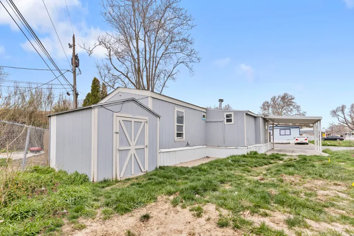 View of shed featuring an attached carport