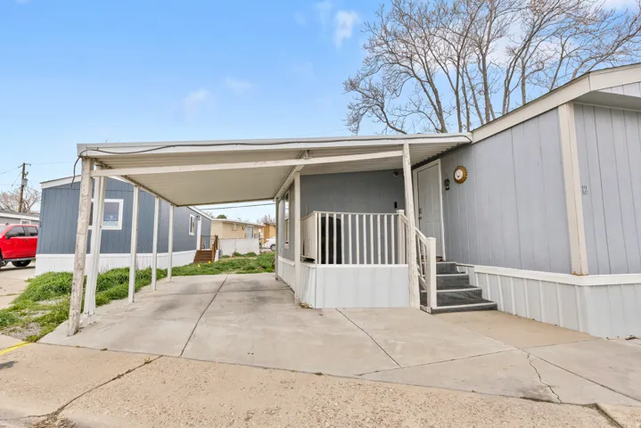 View of parking featuring a carport and concrete driveway