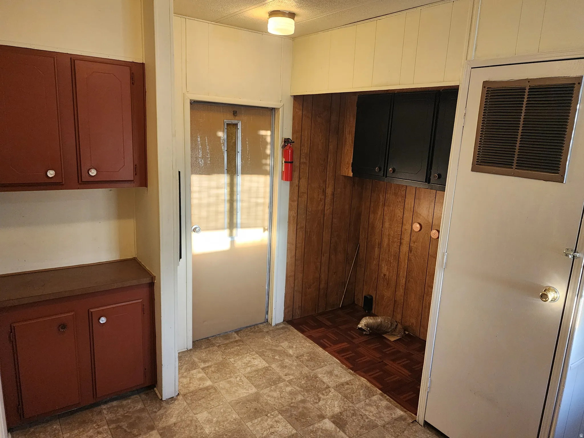 Kitchen with a heating unit and dark countertops