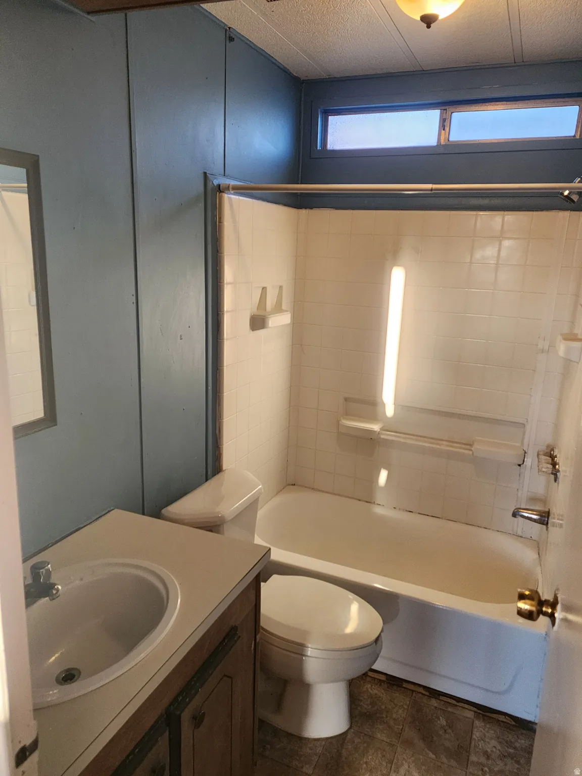 Bathroom with vanity and tub / shower combination