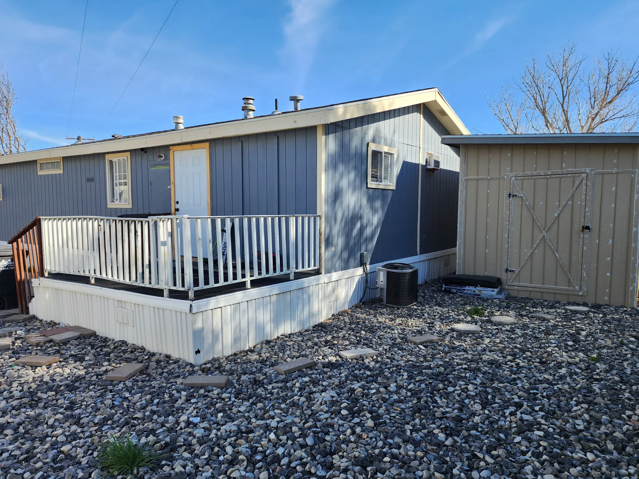 View of home's exterior featuring a deck and a shed