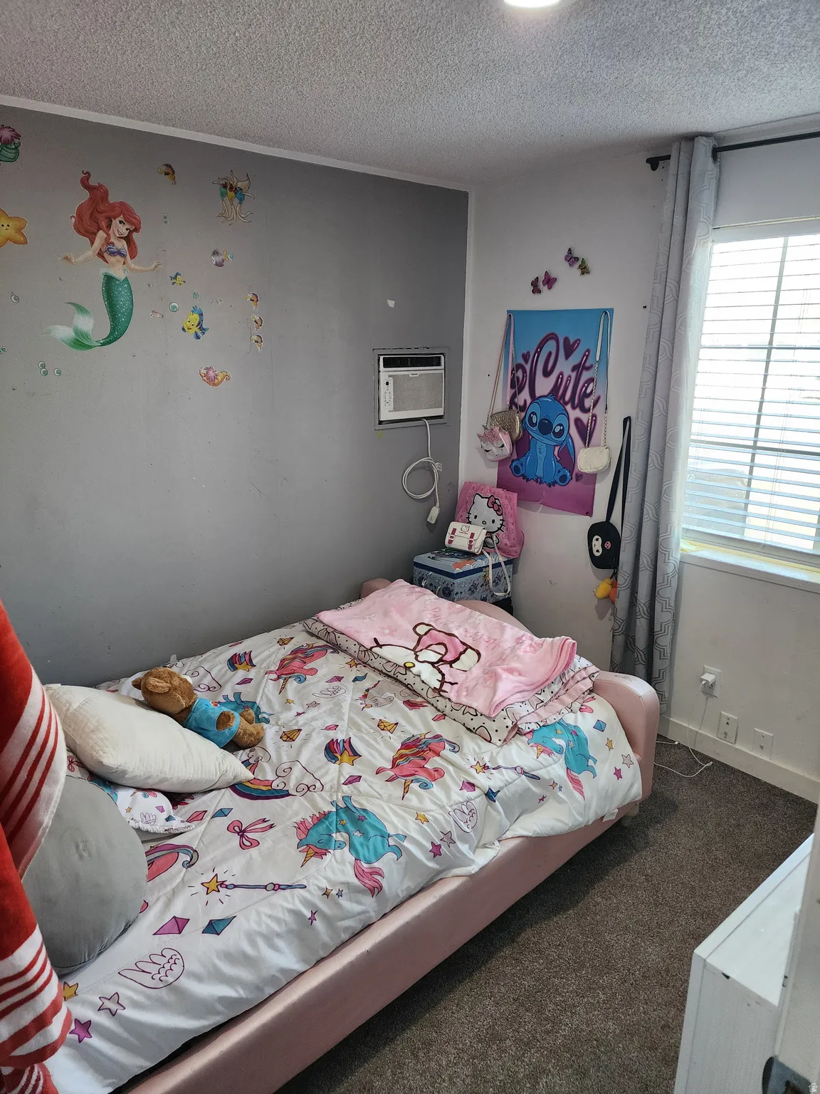 Bedroom featuring carpet flooring and a textured ceiling