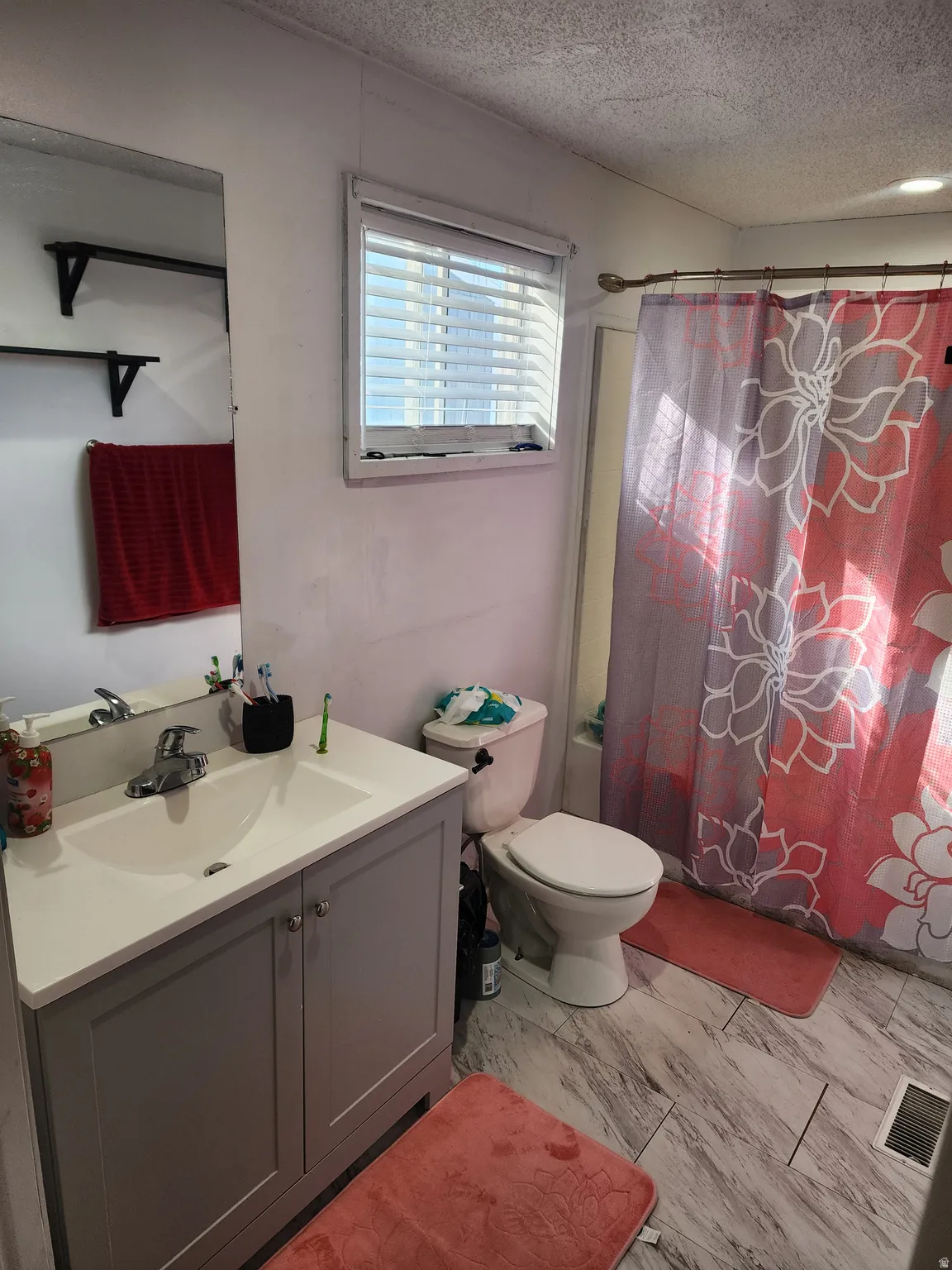 Full bathroom featuring vanity and a textured ceiling