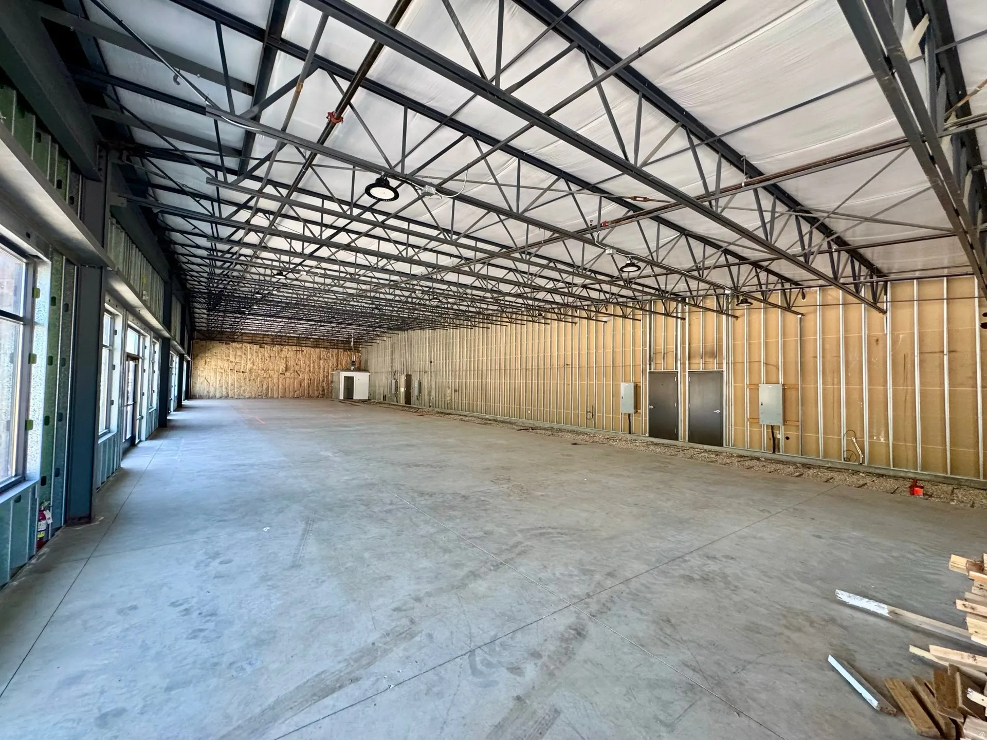 Misc room with a high ceiling and metal wall