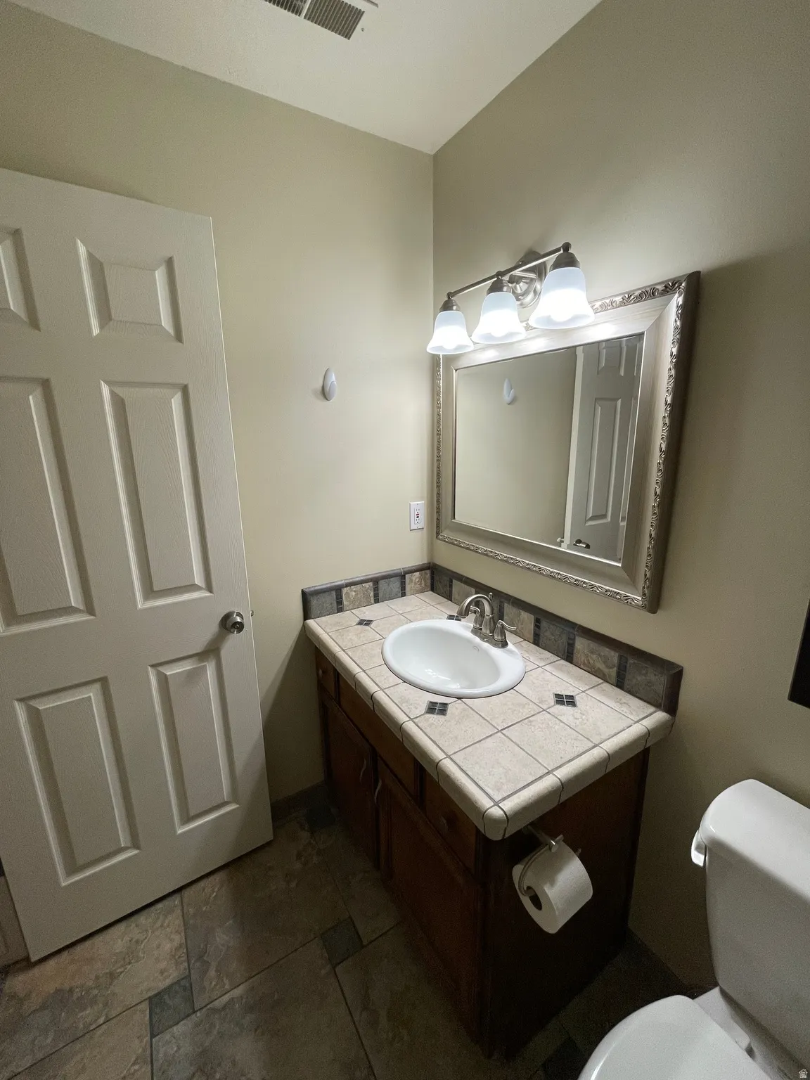 Bathroom featuring vanity and toilet