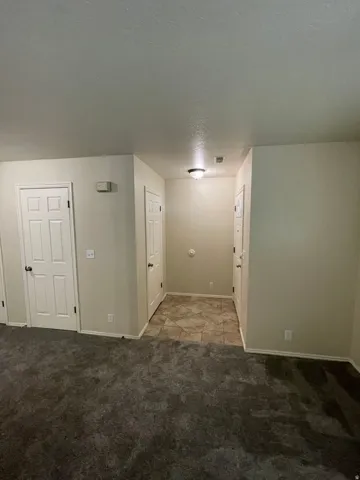 Spare room with a textured ceiling and light carpet