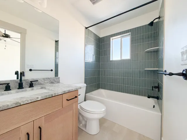 Bathroom in Bedroom 2 with vanity, bathtub / shower combination, and a ceiling fan