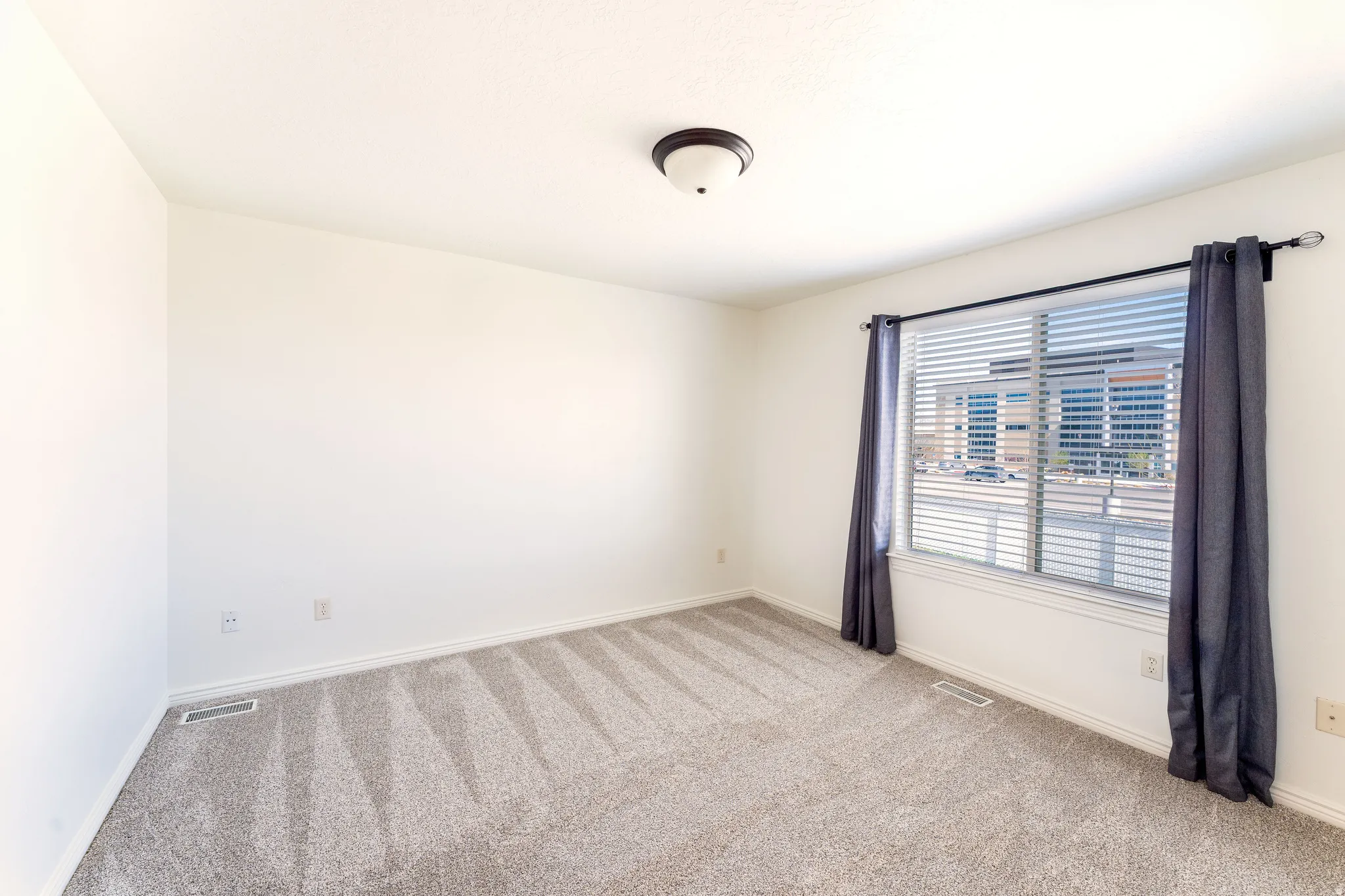 Unfurnished room with baseboards and light colored carpet