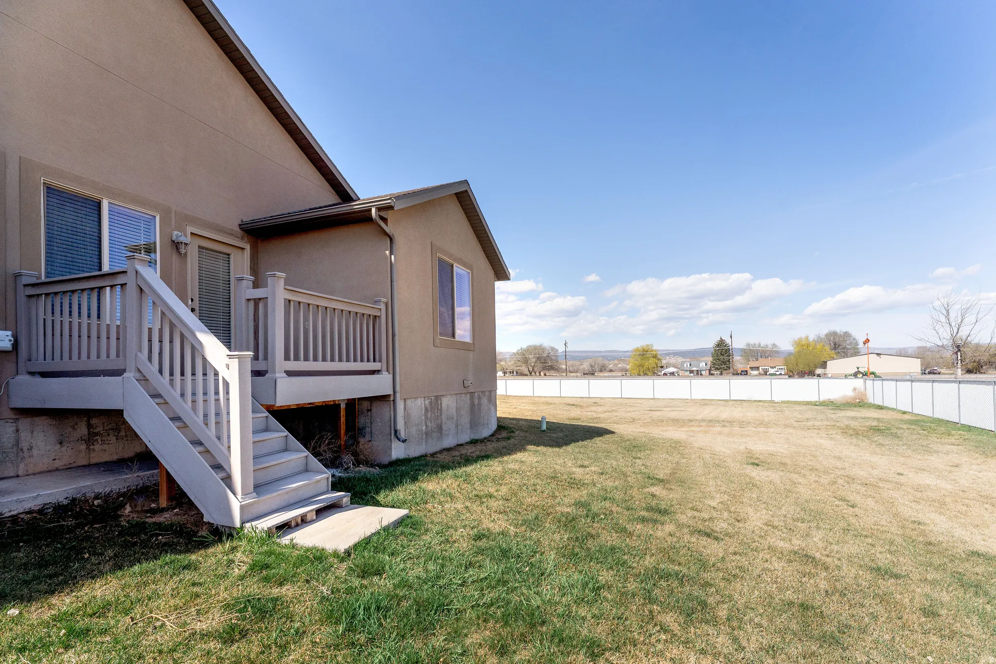 Fenced backyard with stairway and a wooden deck