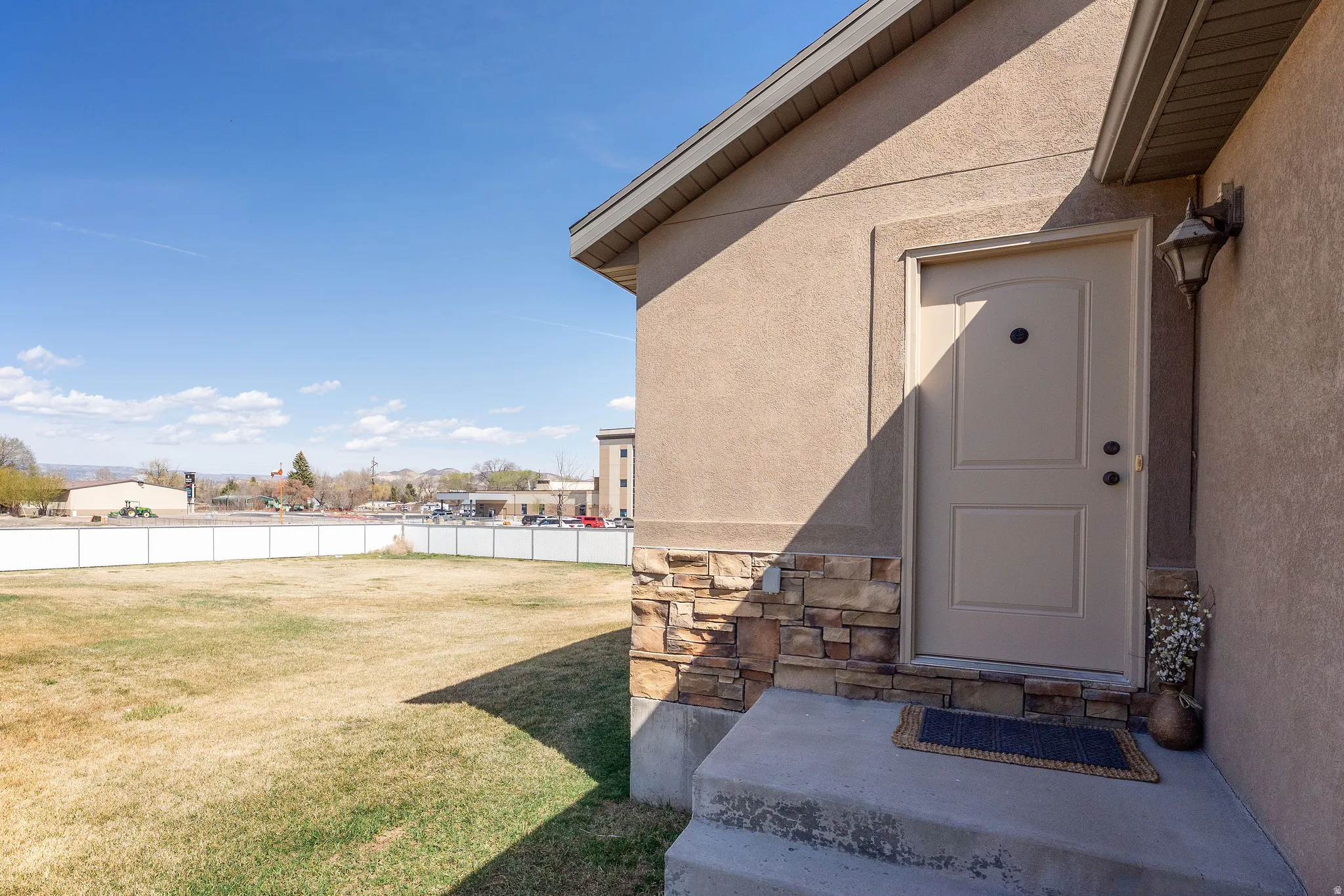 View of exterior entry featuring stucco siding and stone siding