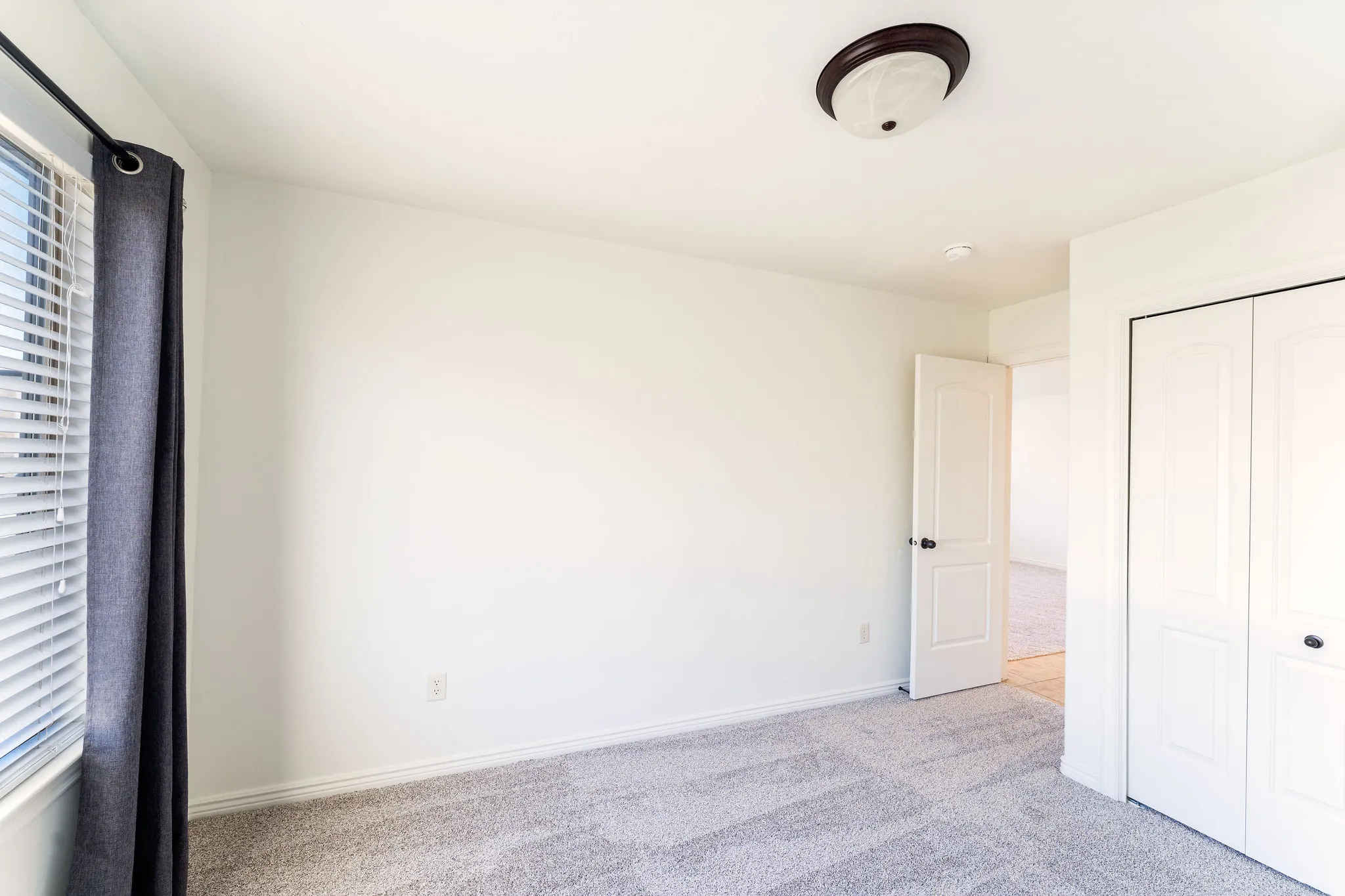 Unfurnished bedroom with carpet and a closet