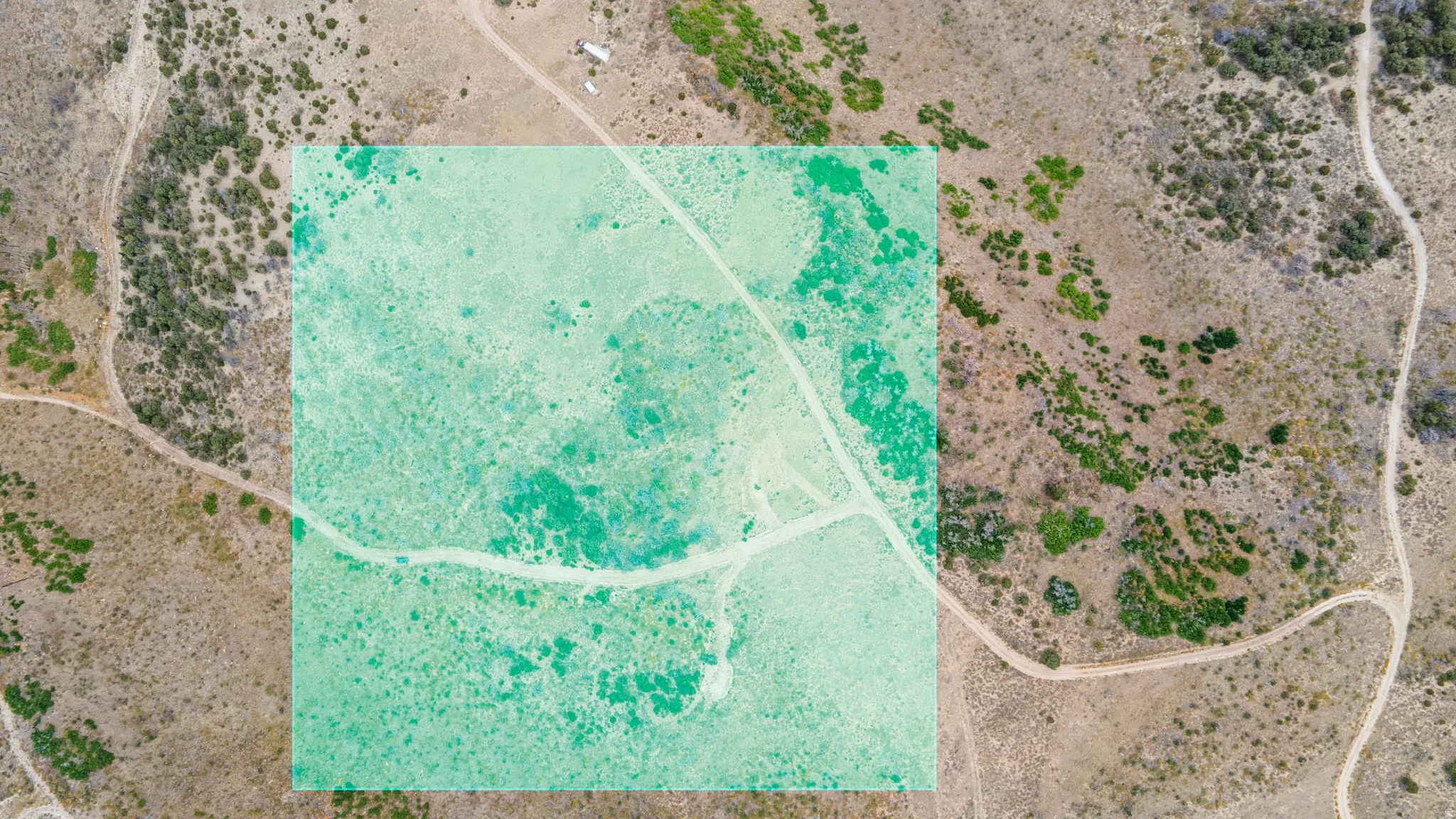 Aerial view of sparsely populated area with a desert landscape and property boundaries highlighted