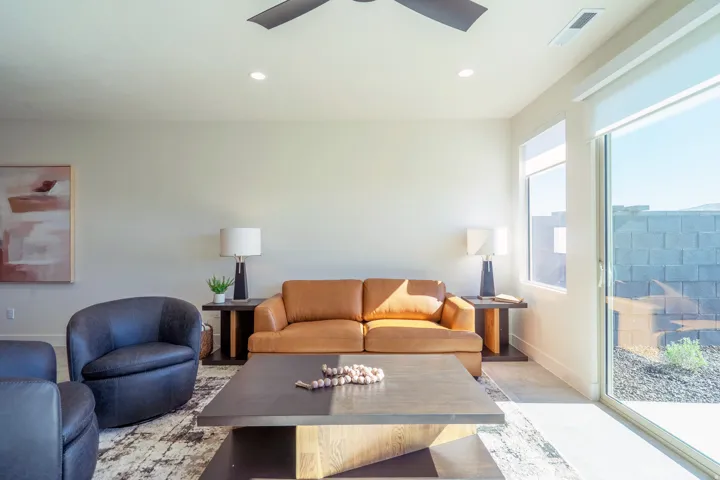 Living room with a ceiling fan and recessed lighting