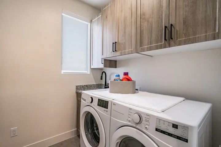 Laundry area featuring cabinet space and washing machine and clothes dryer