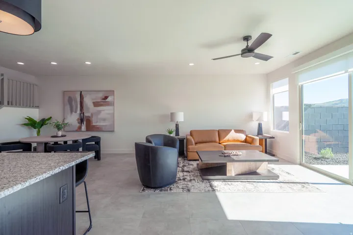 Living room featuring a ceiling fan and recessed lighting