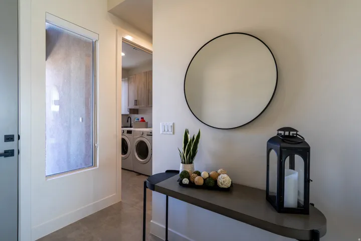 Hallway featuring washer and clothes dryer and baseboards