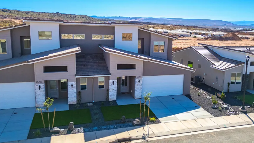 Contemporary house with a mountain view, driveway, and stucco siding