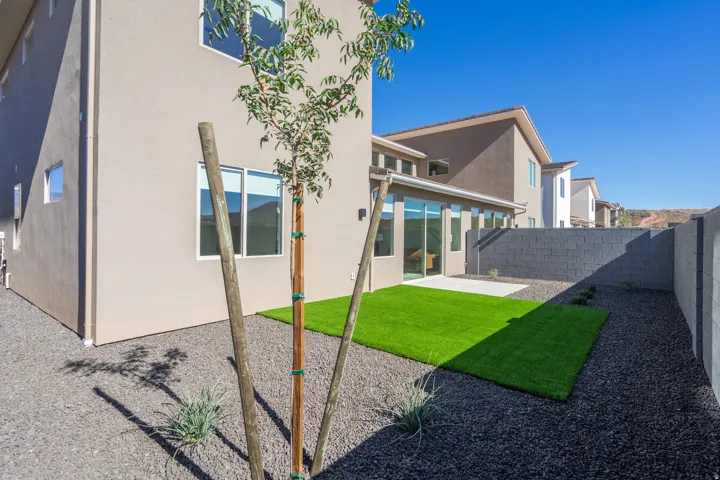 Rear view of house featuring a patio area, a fenced backyard, and stucco siding