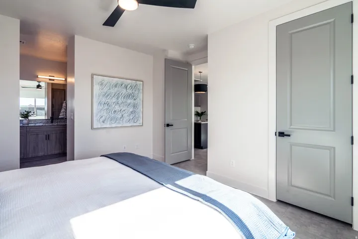 Bedroom with connected bathroom and ceiling fan