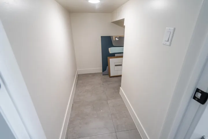 Hall featuring baseboards and concrete floors