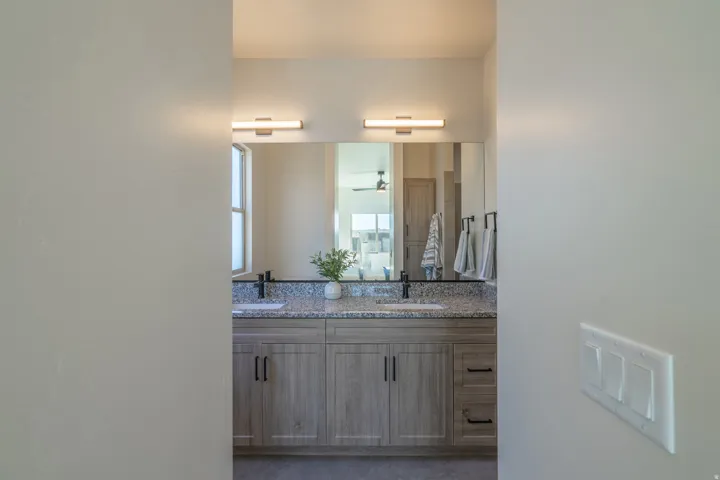 Full bathroom with double vanity and a ceiling fan
