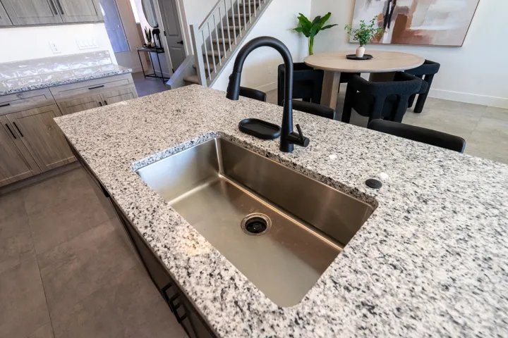 Kitchen view of light stone countertops