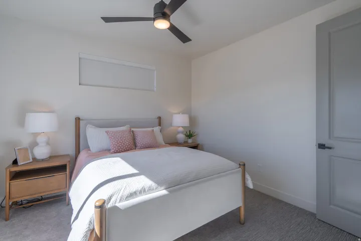 Bedroom with ceiling fan and carpet floors