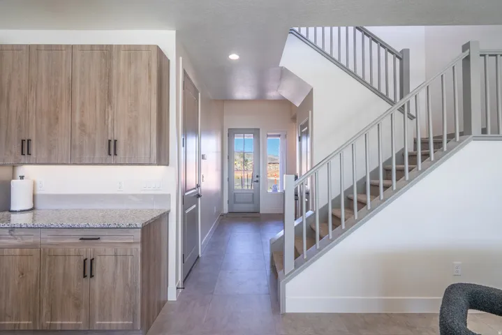 Foyer entrance featuring stairs and recessed lighting