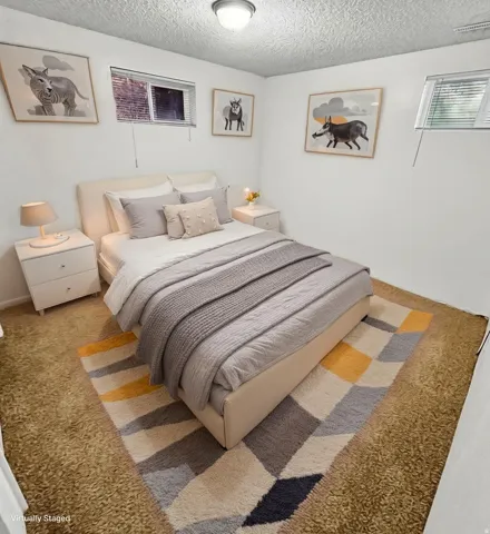 Bedroom featuring a textured ceiling and carpet floors