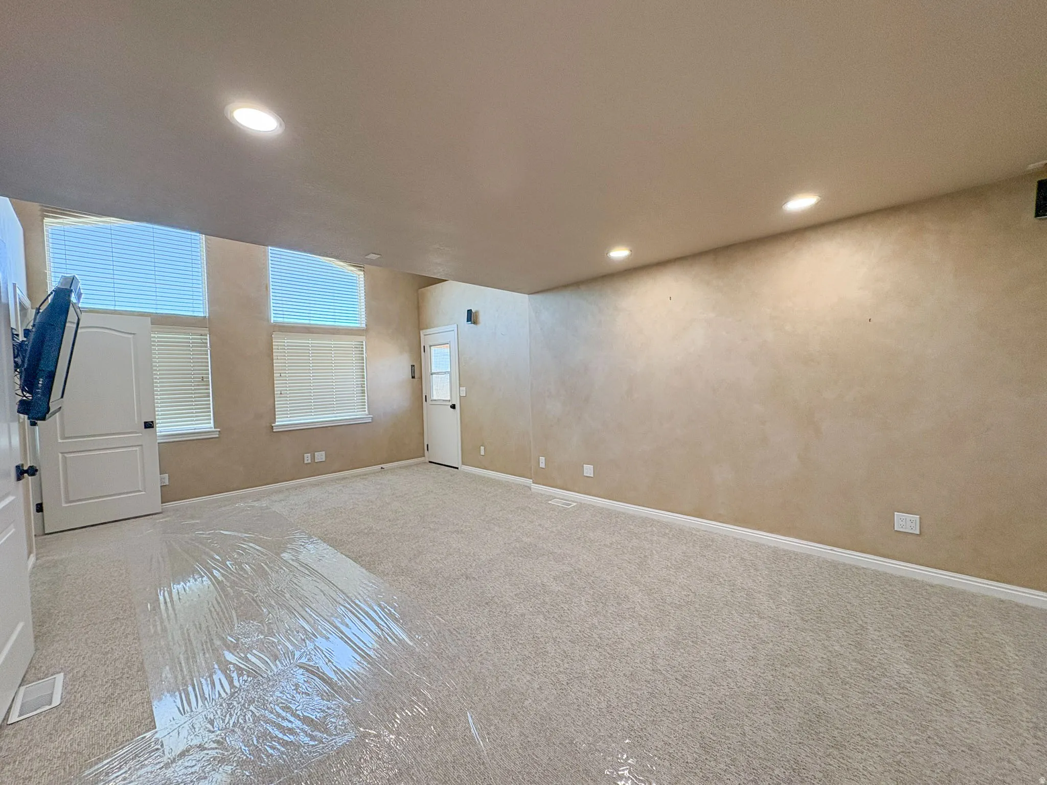 Main bedroom with private balcony and recessed lighting and baseboards