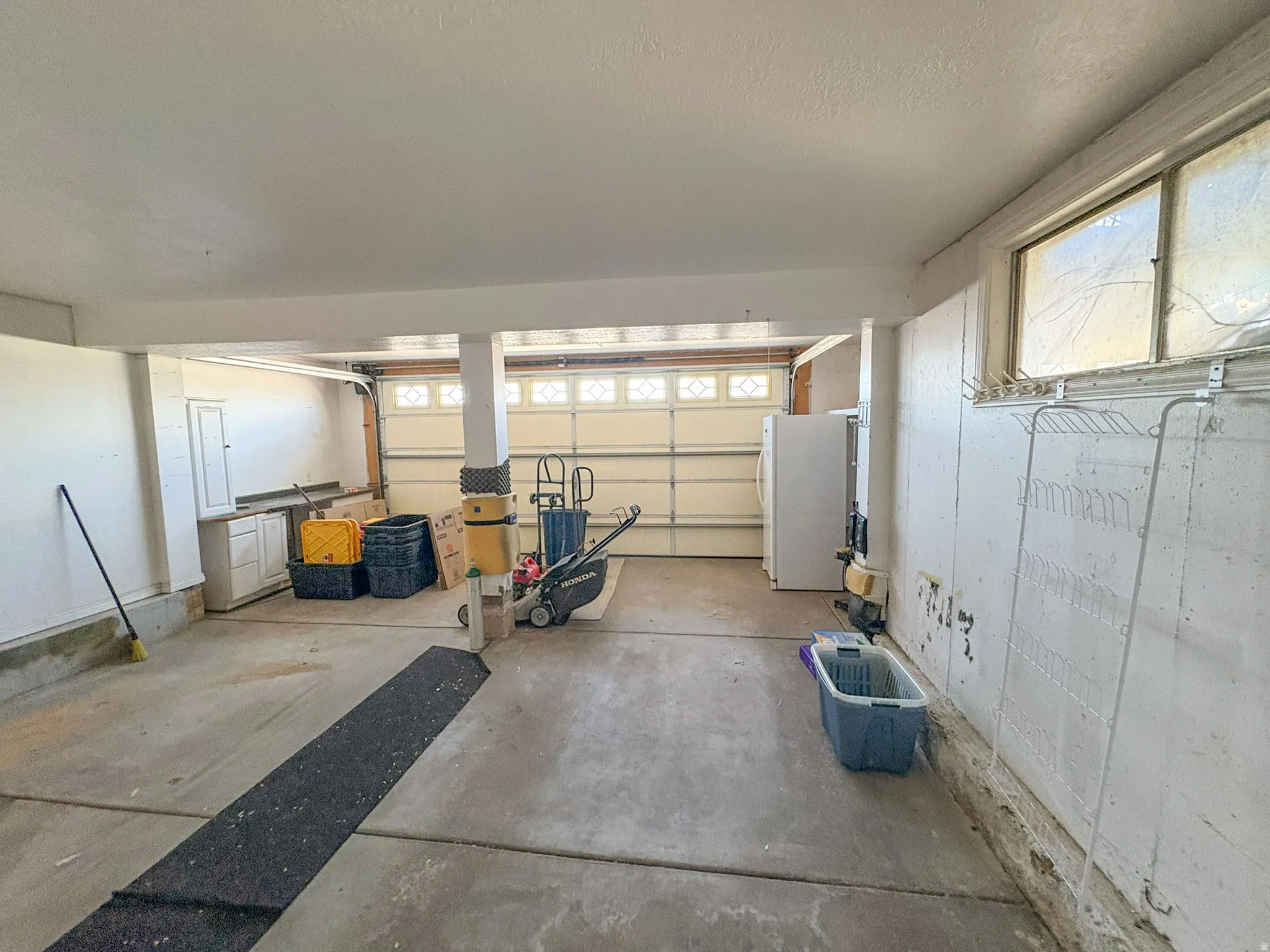 Garage featuring freestanding refrigerator