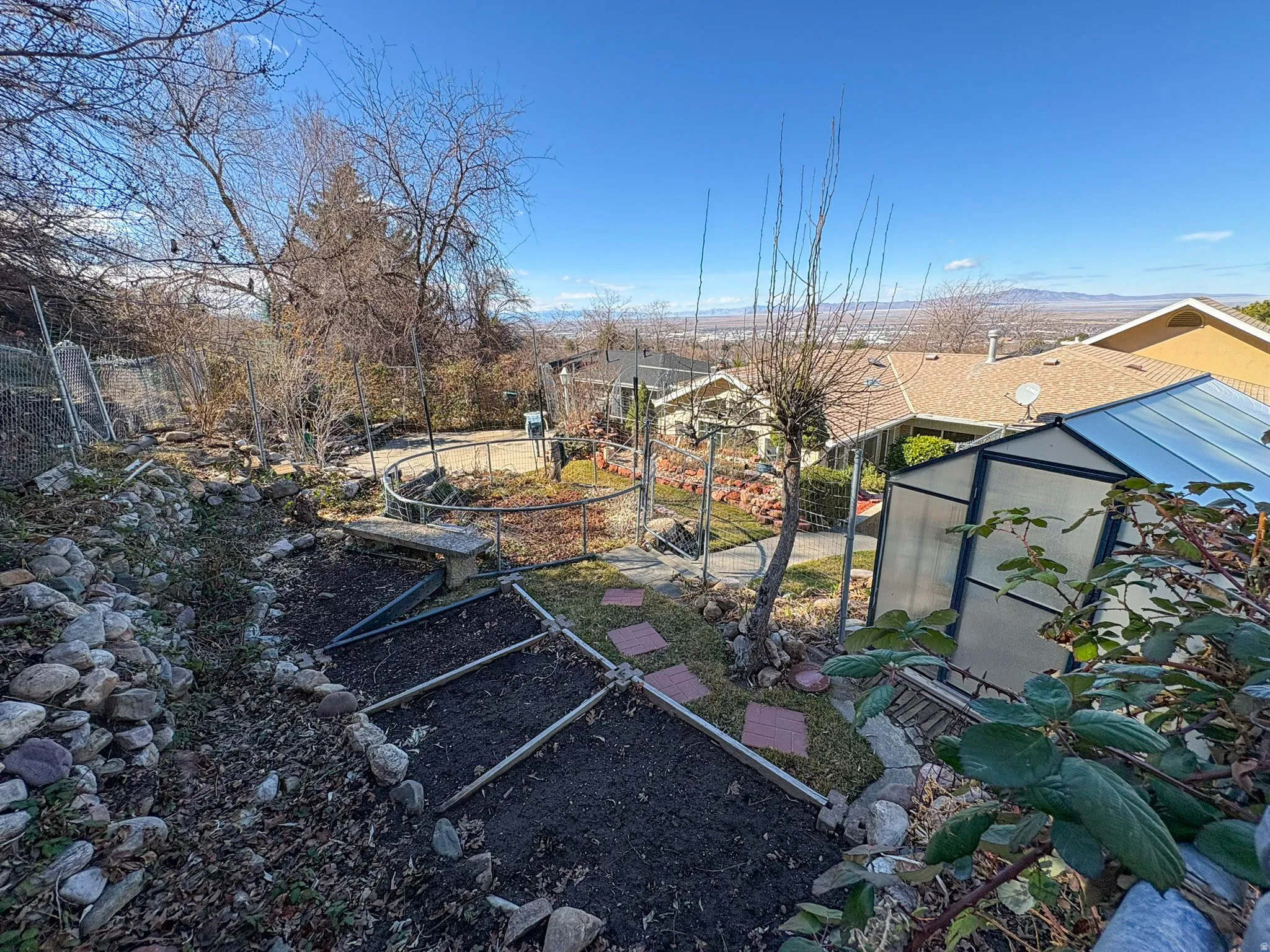 View of yard featuring an outbuilding, an exterior structure, and a garden