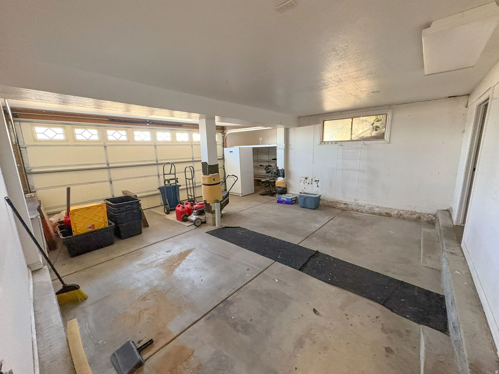 Garage with freestanding refrigerator