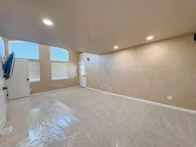 Main bedroom with private balcony and recessed lighting and baseboards