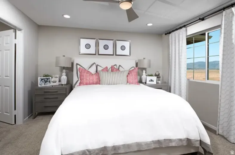 Primary bedroom with light colored carpet, a ceiling fan prewire, and recessed lighting. Pictures are of a model home only! This home may feature different finishes than what is pictured.