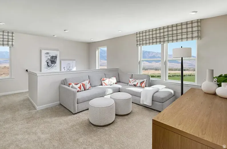 LOFT! Living room with plenty of natural light, light carpet, and recessed lighting and a ceiling fan prewire. Pictures are of a model home only! This home may feature different finishes than what is pictured.