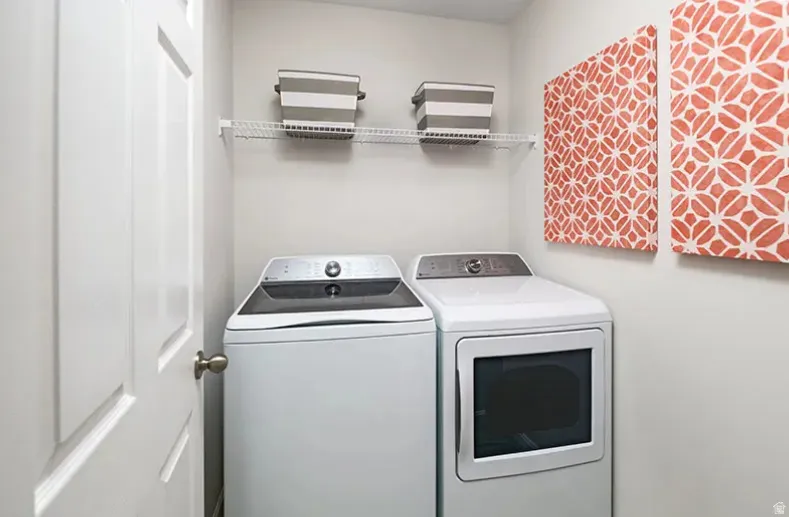 Laundry area with washer and dryer. Pictures are of a model home only! This home may feature different finishes than what is pictured.