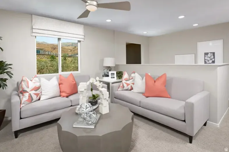 Living room featuring a ceiling fan prewire, recessed lighting, and light carpet. Pictures are of a model home only! This home may feature different finishes than what is pictured.