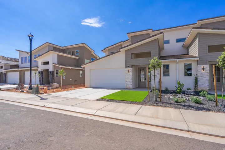 Contemporary exterior featuring stucco and horizontal siding with stone veneer accents