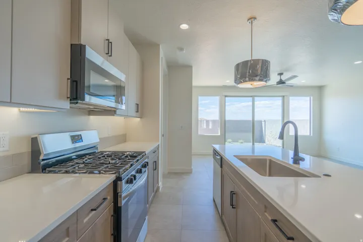 Modern kitchen featuring an island with an undermount sink and a matte black faucet