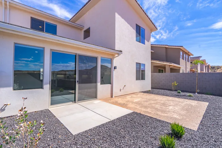 Rear exterior with stucco siding and multiple windows