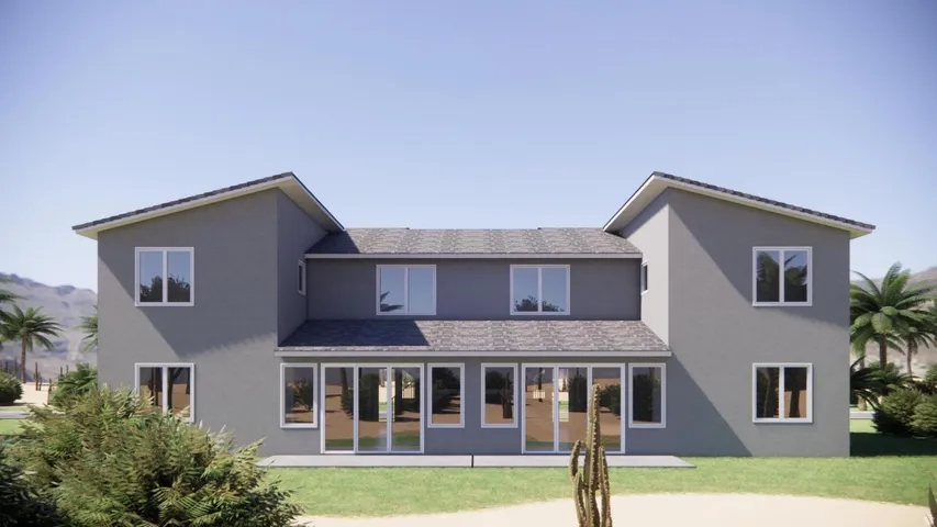 Back of house featuring a shingled roof, a yard, stucco siding, and a patio