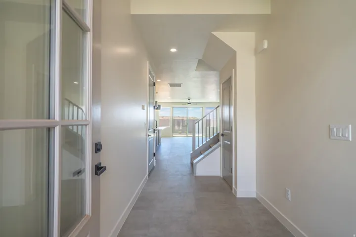 Light-toned plank flooring extends through a welcoming entry foyer
