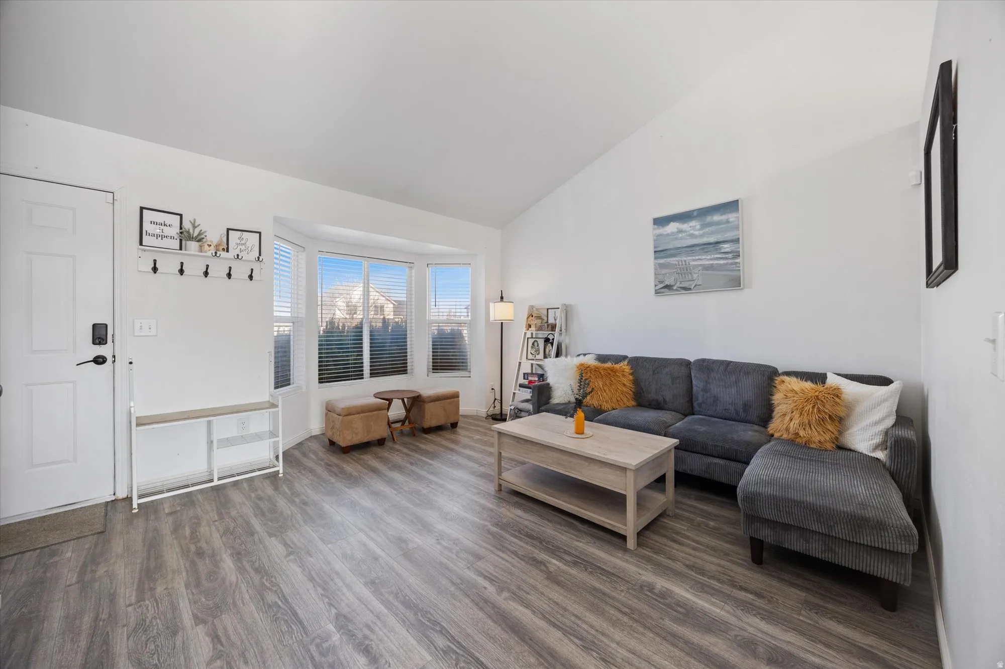 Living room featuring dark wood finished floors and vaulted ceiling
