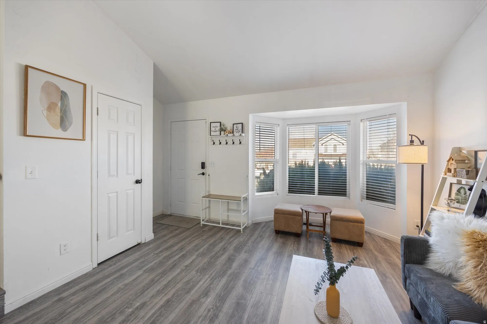 Living area featuring vaulted ceiling and wood finished floors